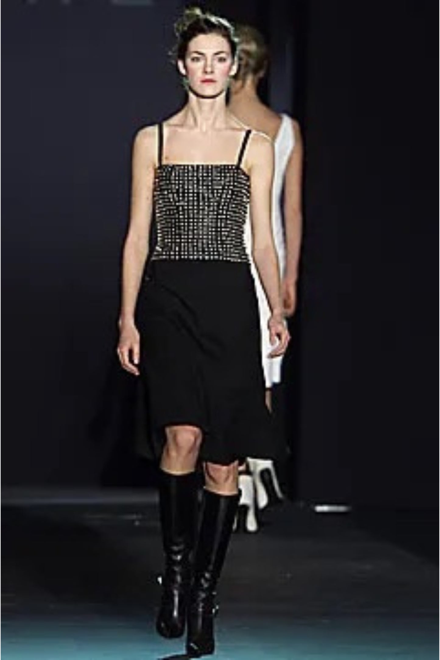 Loewe by Narciso Rodriguez AW01 studded leather dress label detail: close-up of Loewe Made in Spain garment label with fabric composition tags showing 100% leather bodice and 100% silk skirt, AW2001
