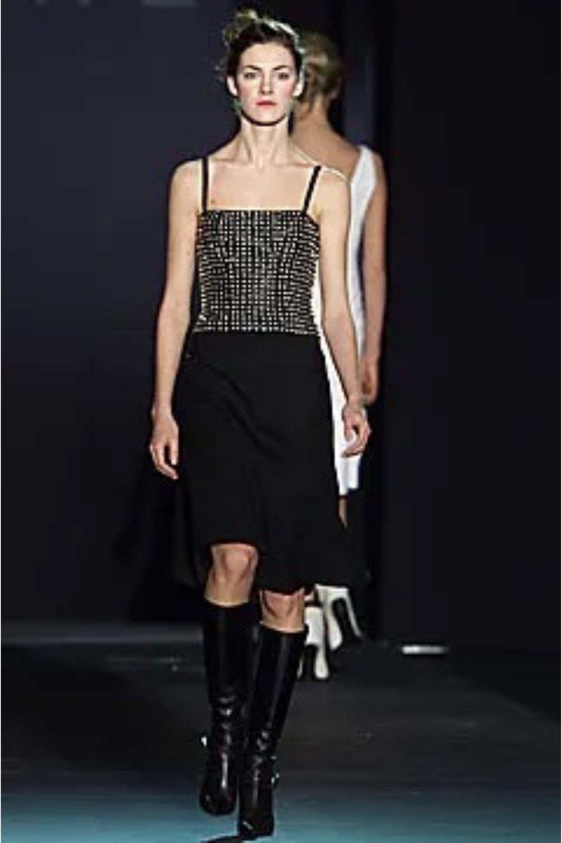 Loewe by Narciso Rodriguez AW01 studded leather dress label detail: close-up of Loewe Made in Spain garment label with fabric composition tags showing 100% leather bodice and 100% silk skirt, AW2001