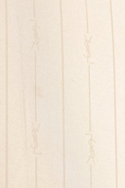 Vintage YSL Yves Saint Laurent gold umbrella: side profile view of the closed umbrella showing the full length slim silhouette and canopy fabric condition