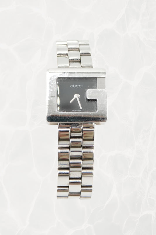 Tom Ford for Gucci G-Frame stainless steel watch, front view — black dial with silver baton hands and G-shaped bezel