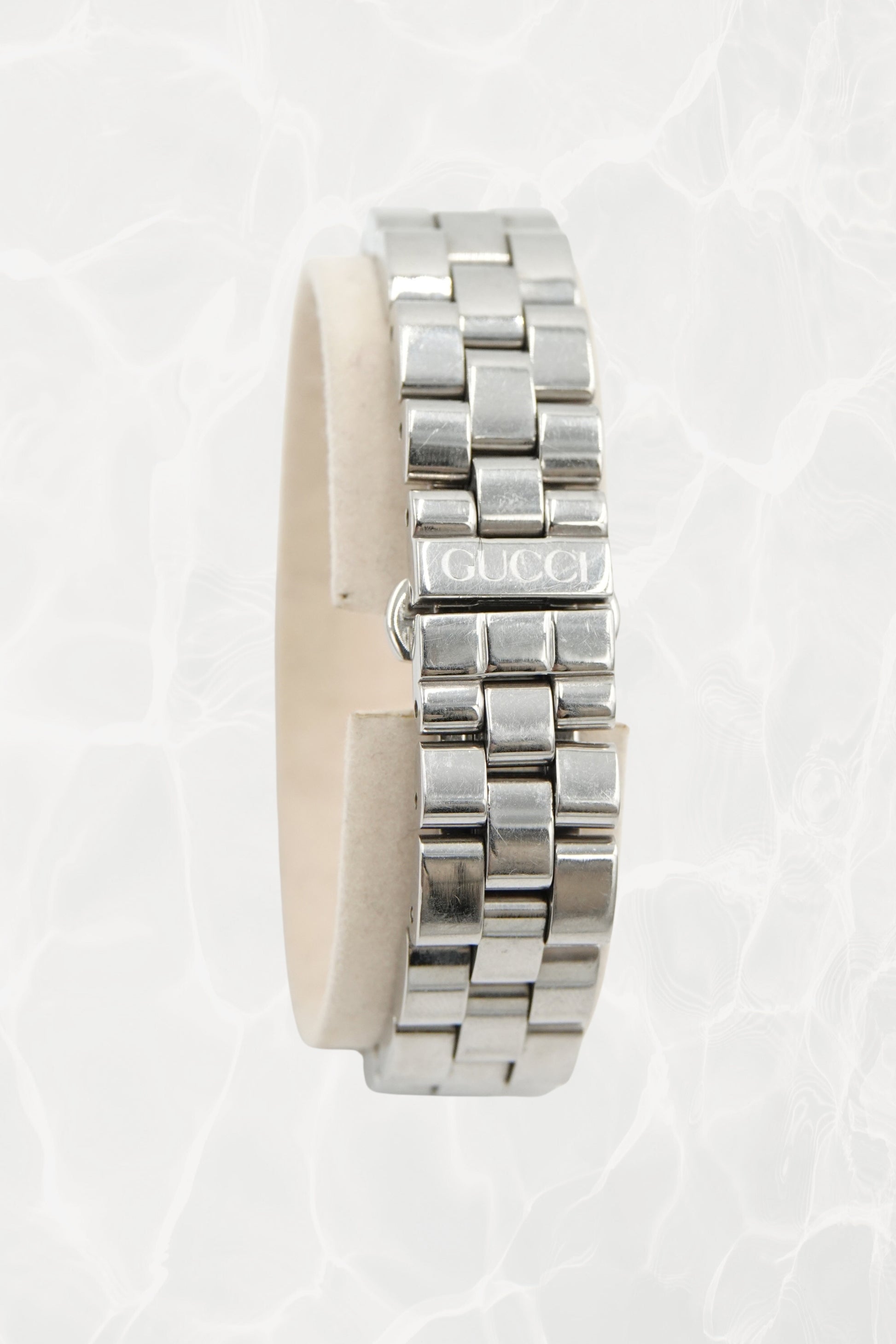 Tom Ford for Gucci G-Frame watch side view showing fold-over clasp with Gucci text